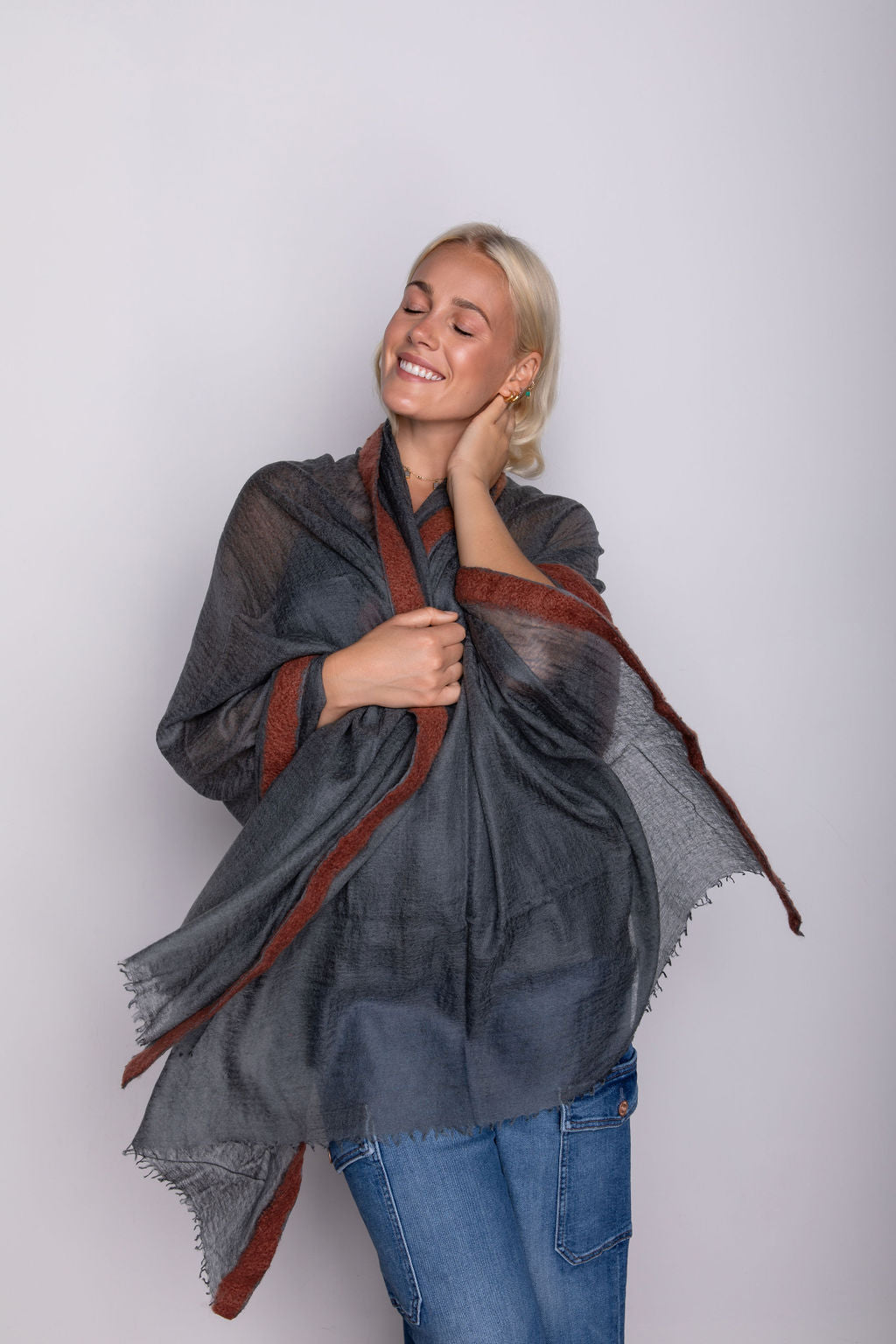  A variety of women's cashmere shawls displayed in chic arrangements, offering timeless elegance and cozy comfort.